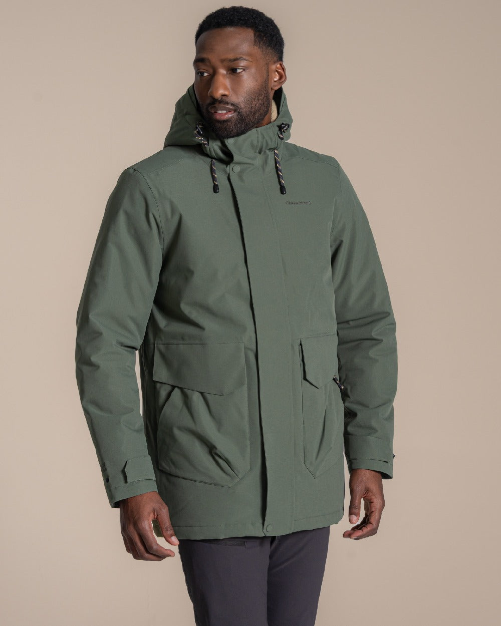 Lagano Green coloured Craghoppers Mens Agnar Jacket on beige background 