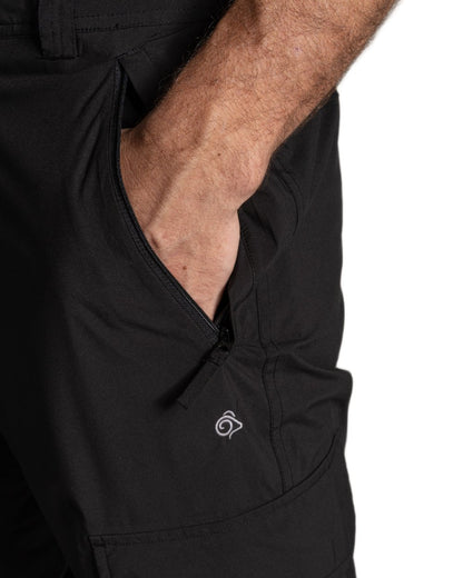 Black coloured Craghoppers Mens Indus Waterproof Lightweight Cargo Trousers on white background 