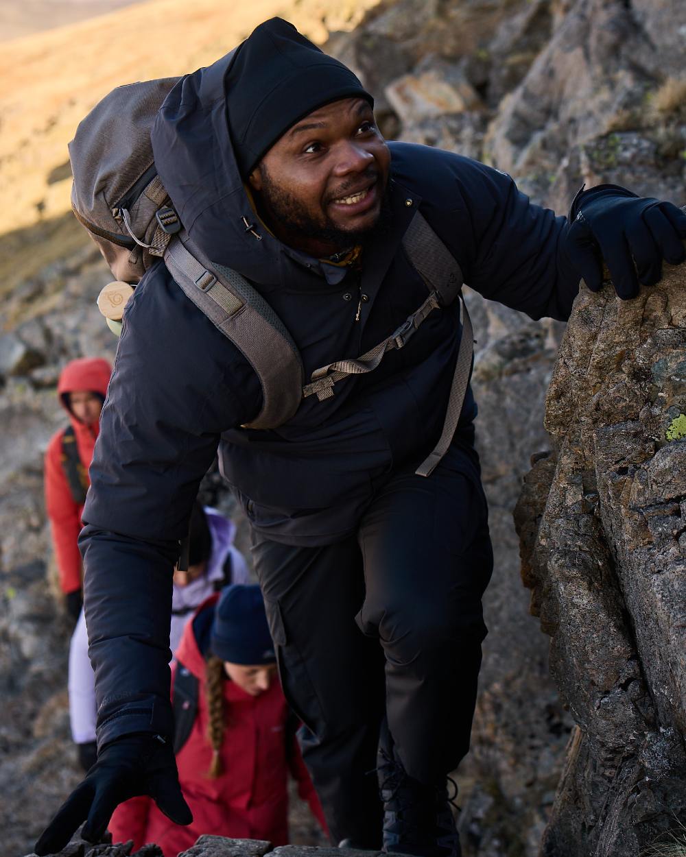Black coloured Craghoppers Mens Indus Waterproof Lightweight Cargo Trousers on mountain background 