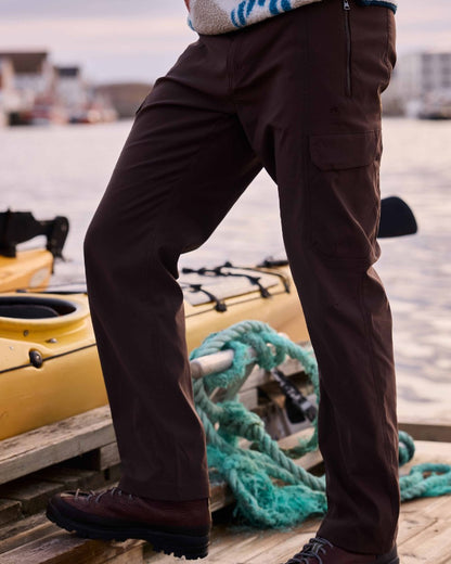 Wenge Brown coloured Craghoppers Mens Kiwi Pro Cargo Trousers on sea background 