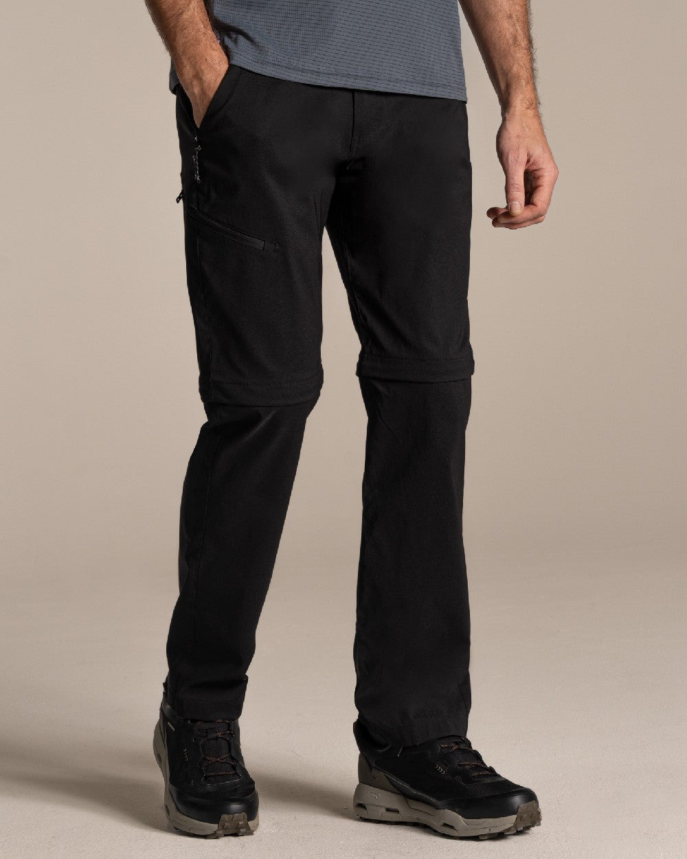 Black Coloured Craghoppers Mens Kiwi Pro III Convertible Trouser on Beige Background 