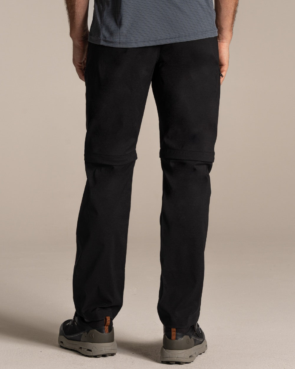 Black Coloured Craghoppers Mens Kiwi Pro III Convertible Trouser on Beige Background 