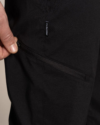 Black Coloured Craghoppers Mens Kiwi Pro III Convertible Trouser on Beige Background 