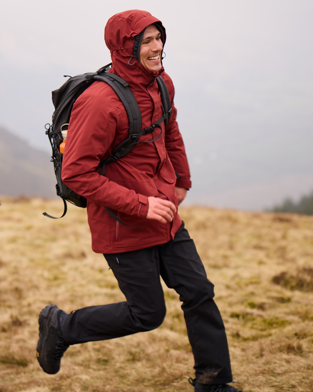 Red Jasper coloured Craghoppers Mens Lorton II Waterproof Jacket on mountain background 
