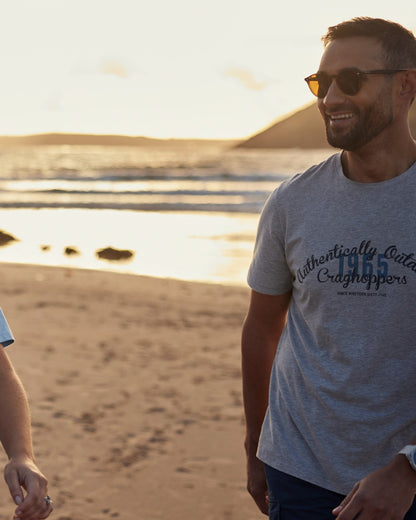 Light Grey Marl Coloured Craghoppers Mens Lucent II Short Sleeved T-Shirt on beach Background
