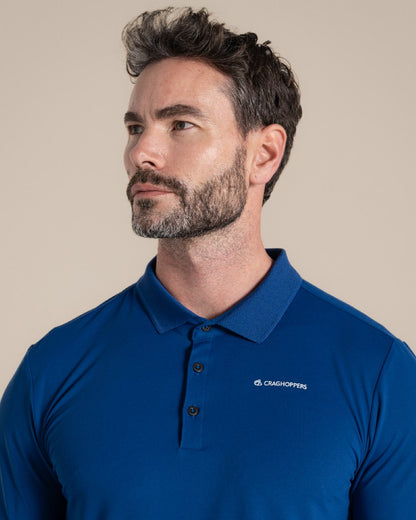 Deep Marina Coloured Craghoppers mens Nosilife Bramshaw Long Sleeved Polo Top on Beige Background 