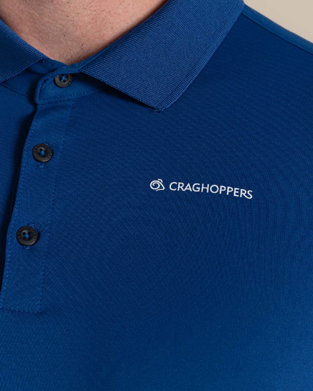 Deep Marina Coloured Craghoppers mens Nosilife Bramshaw Long Sleeved Polo Top on Beige Background 