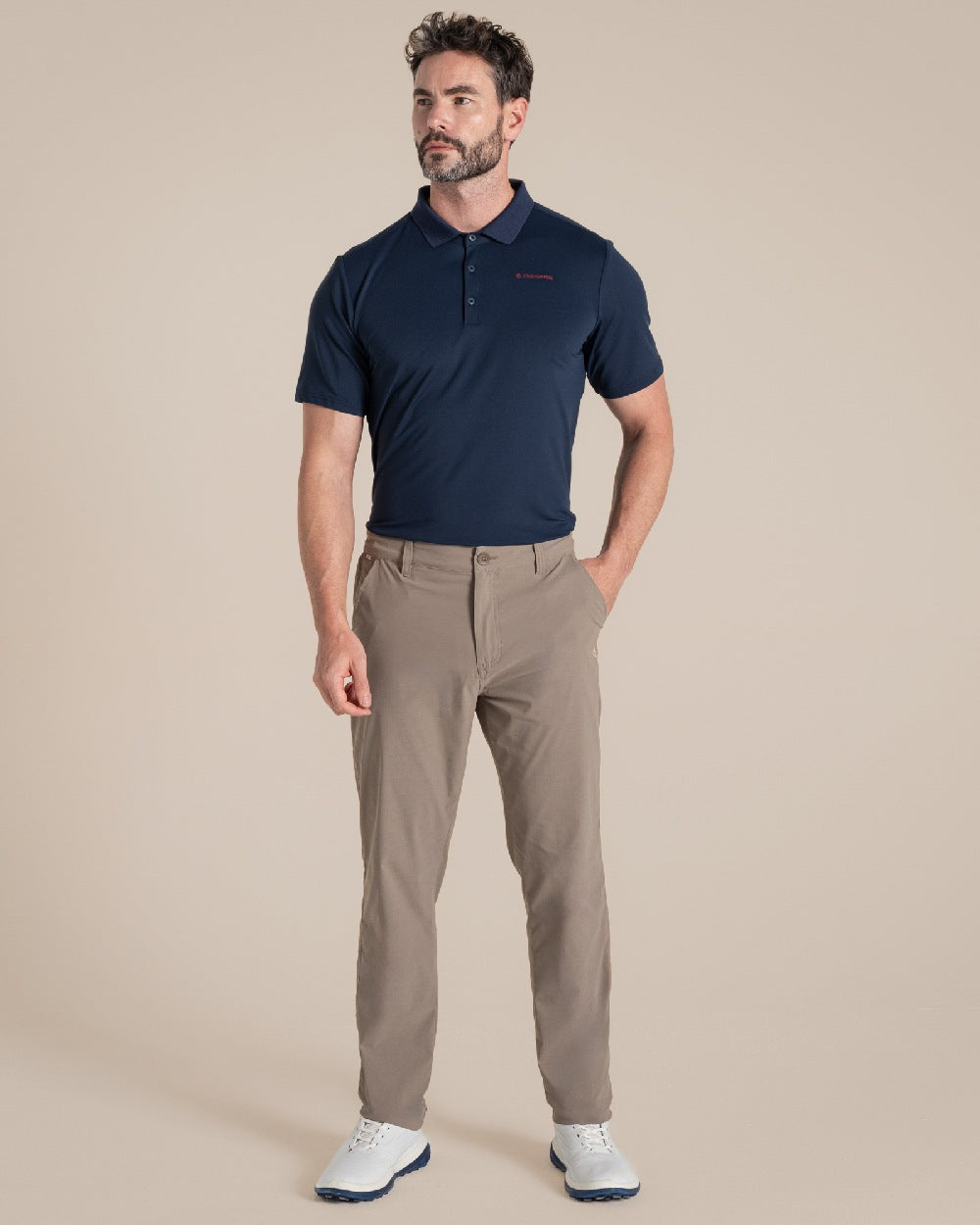 Blue Navy Coloured Craghoppers Mens Nosilife Bramshaw Short Sleeved Polo Top on Beige Background 
