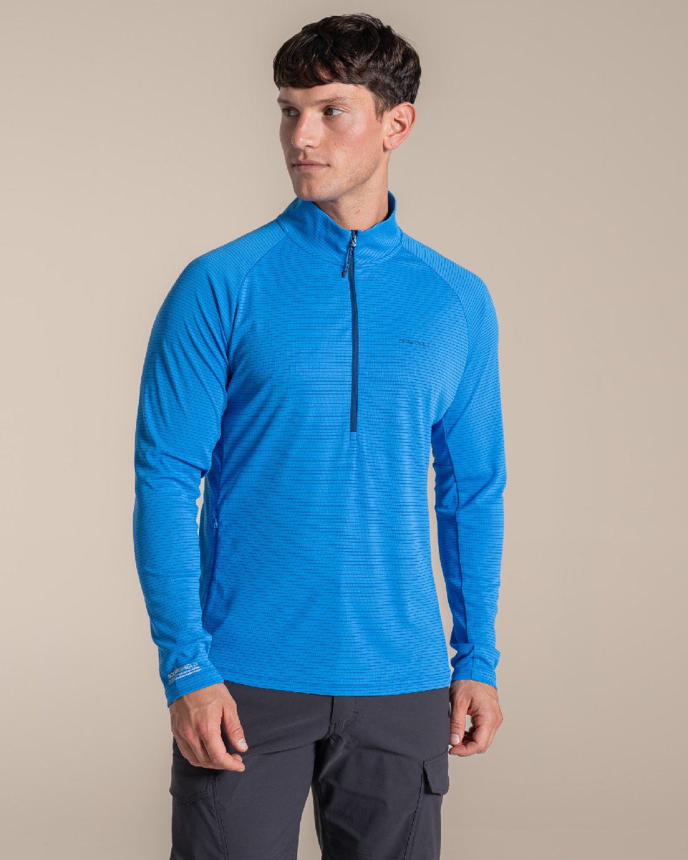 Azure Sky coloured Craghoppers Mens NosiLife SolarShield+ Half Zip Top on beige background 