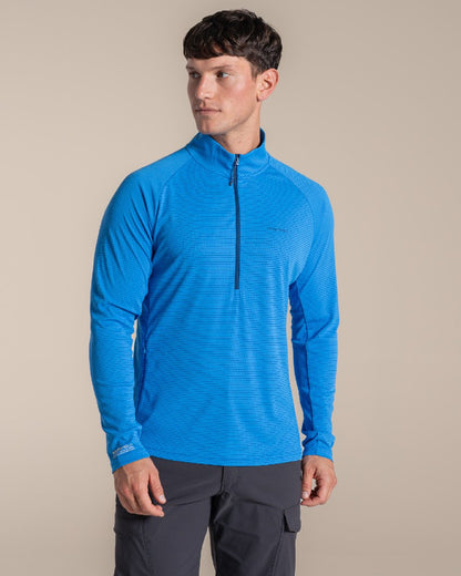 Azure Sky coloured Craghoppers Mens NosiLife SolarShield+ Half Zip Top on beige background 