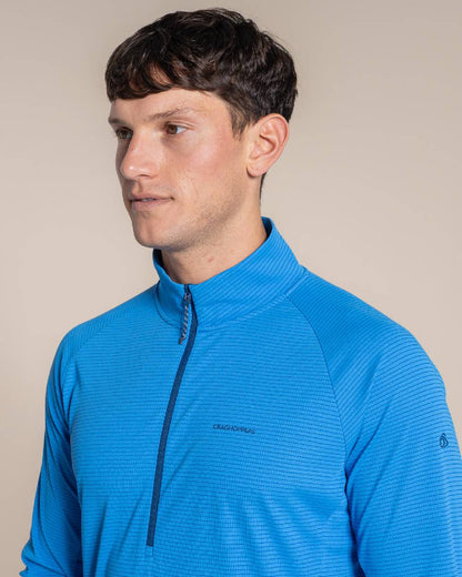 Azure Sky coloured Craghoppers Mens NosiLife SolarShield+ Half Zip Top on beige background 
