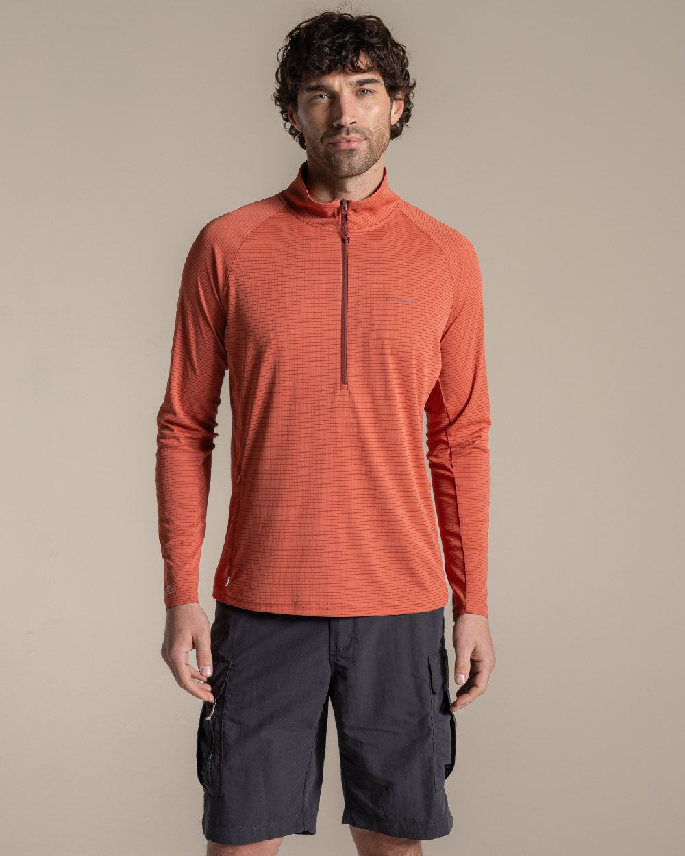 Dark Sahara coloured Craghoppers Mens NosiLife SolarShield+ Half Zip Top on beige background 