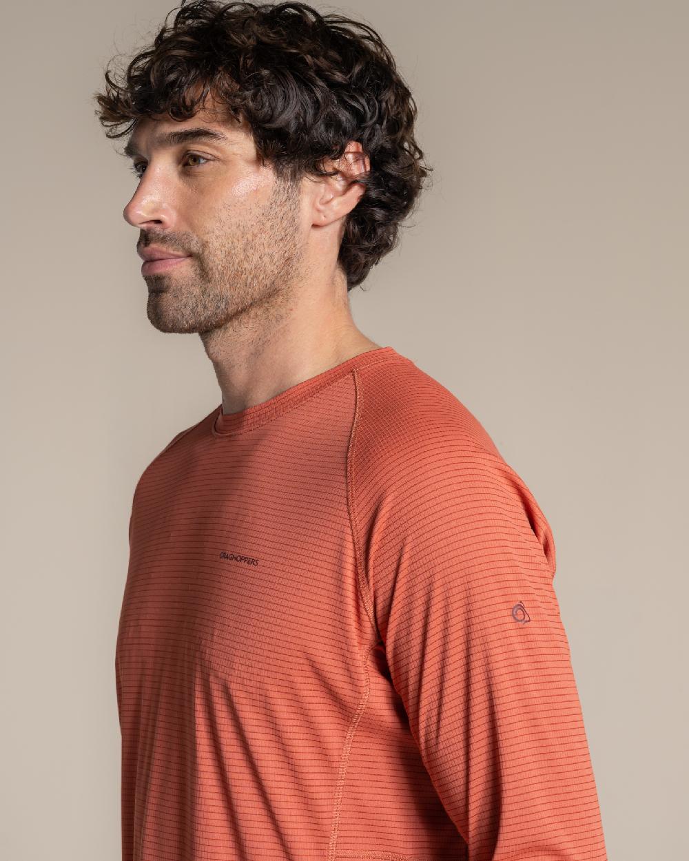 Dark Sahara coloured Craghoppers Mens NosiLife SolarShield+ Long Sleeved T-Shirt on beige background 