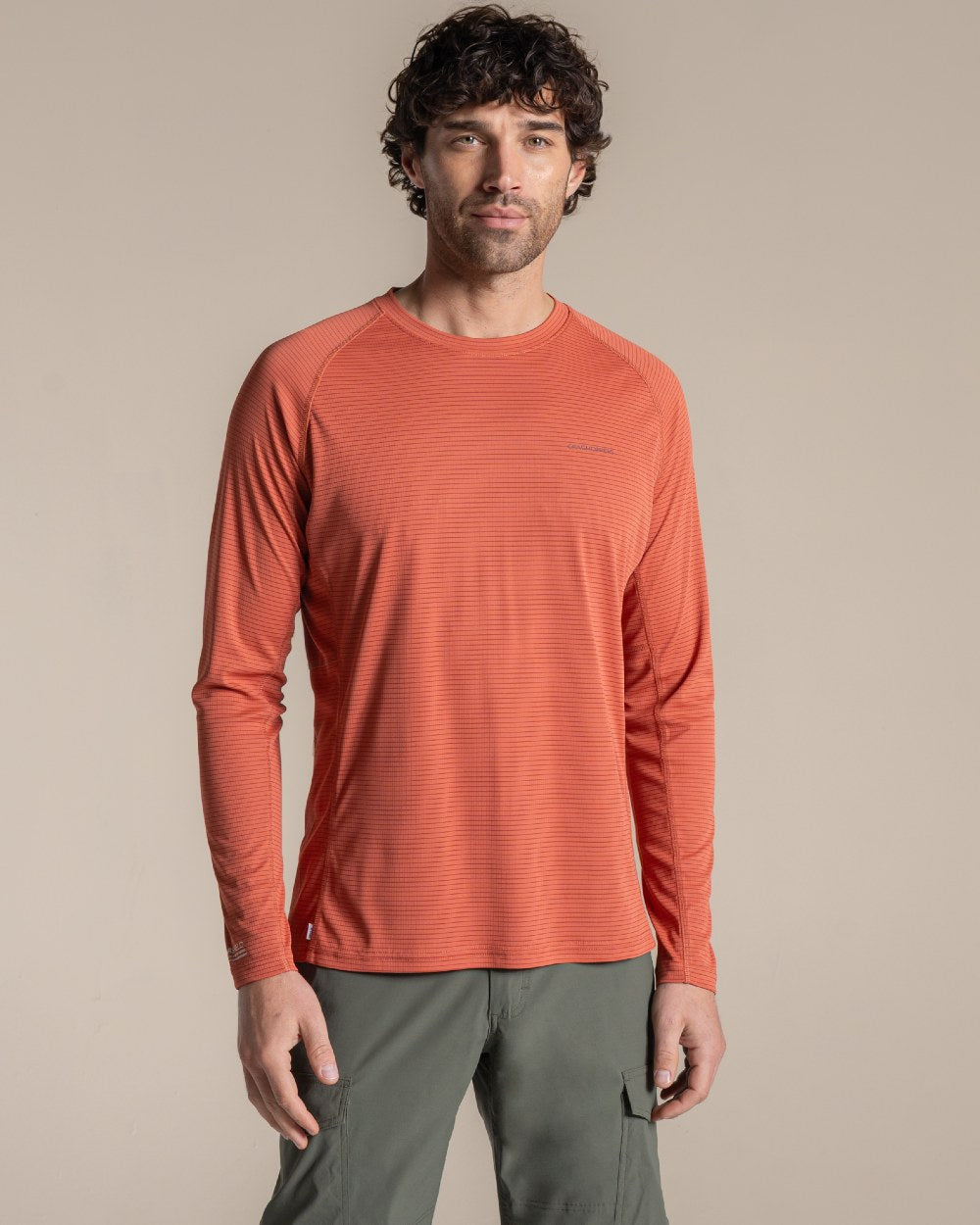 Dark Sahara coloured Craghoppers Mens NosiLife SolarShield+ Long Sleeved T-Shirt on beige background 