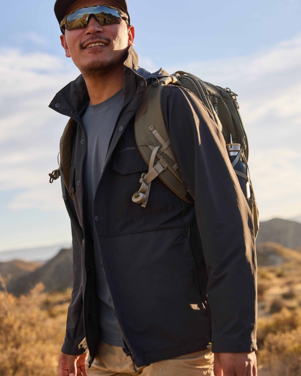Dark Iron coloured Craghoppers Mens NosiLife Younes Jacket on mountain background 
