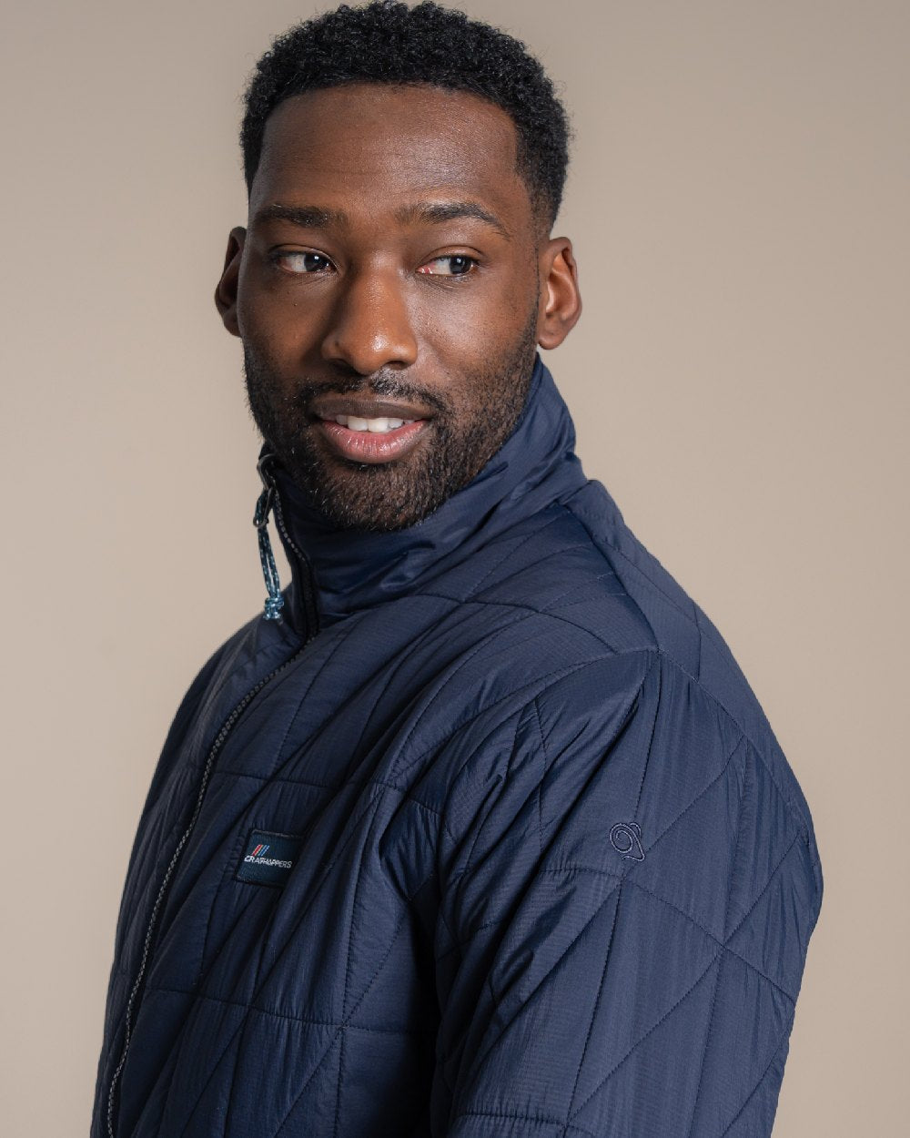 Blue Navy coloured Craghoppers Mens Stuo Jacket on beige background 