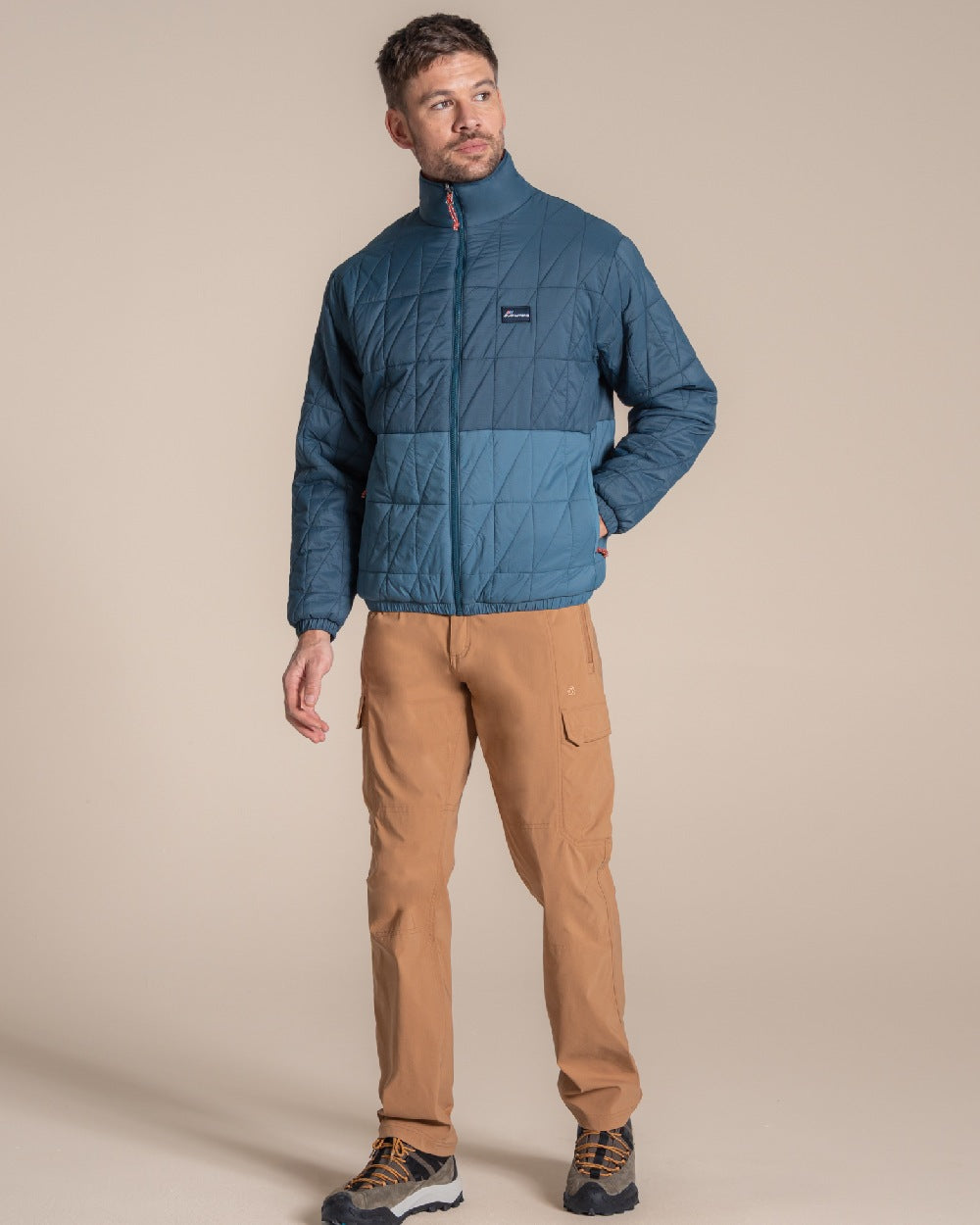 Dark Aegean Blue Winter Storm coloured Craghoppers Stuo Jacket on beige background 