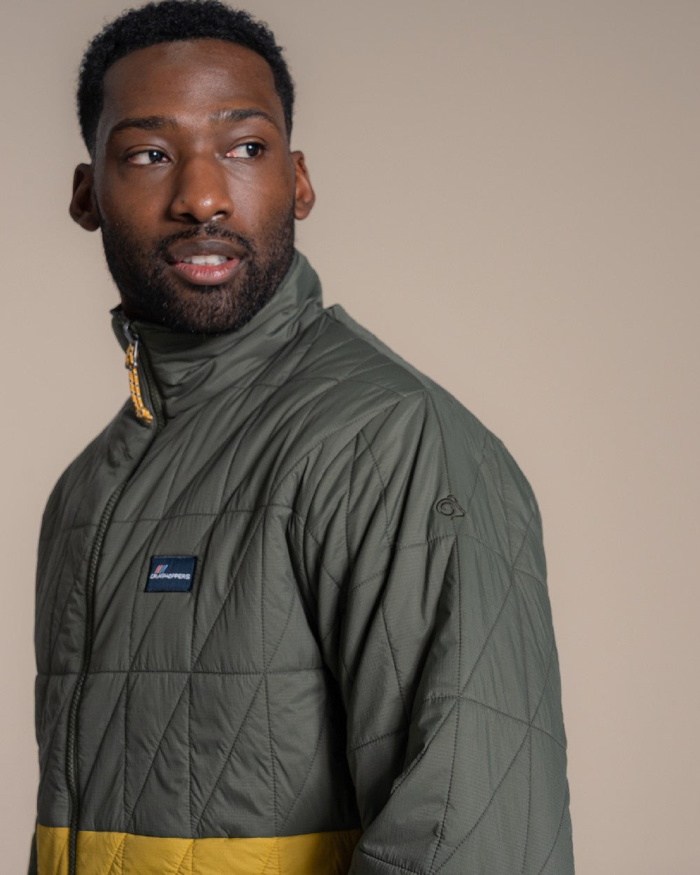 Lagano Green Sulphur Yellow coloured Craghoppers Mens Stuo Jacket on beige background 