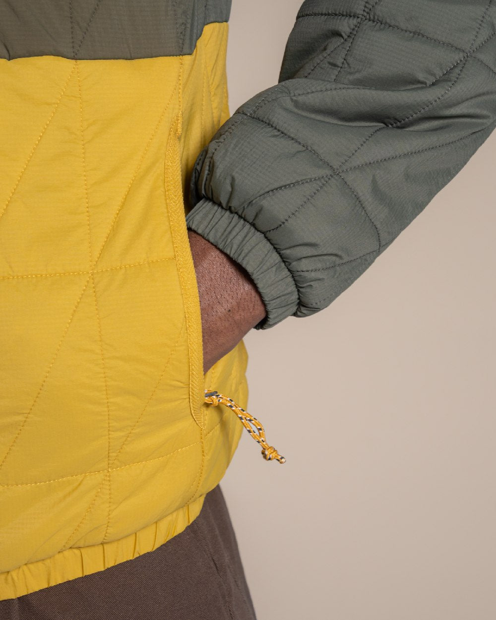 Lagano Green Sulphur Yellow coloured Craghoppers Mens Stuo Jacket on beige background 