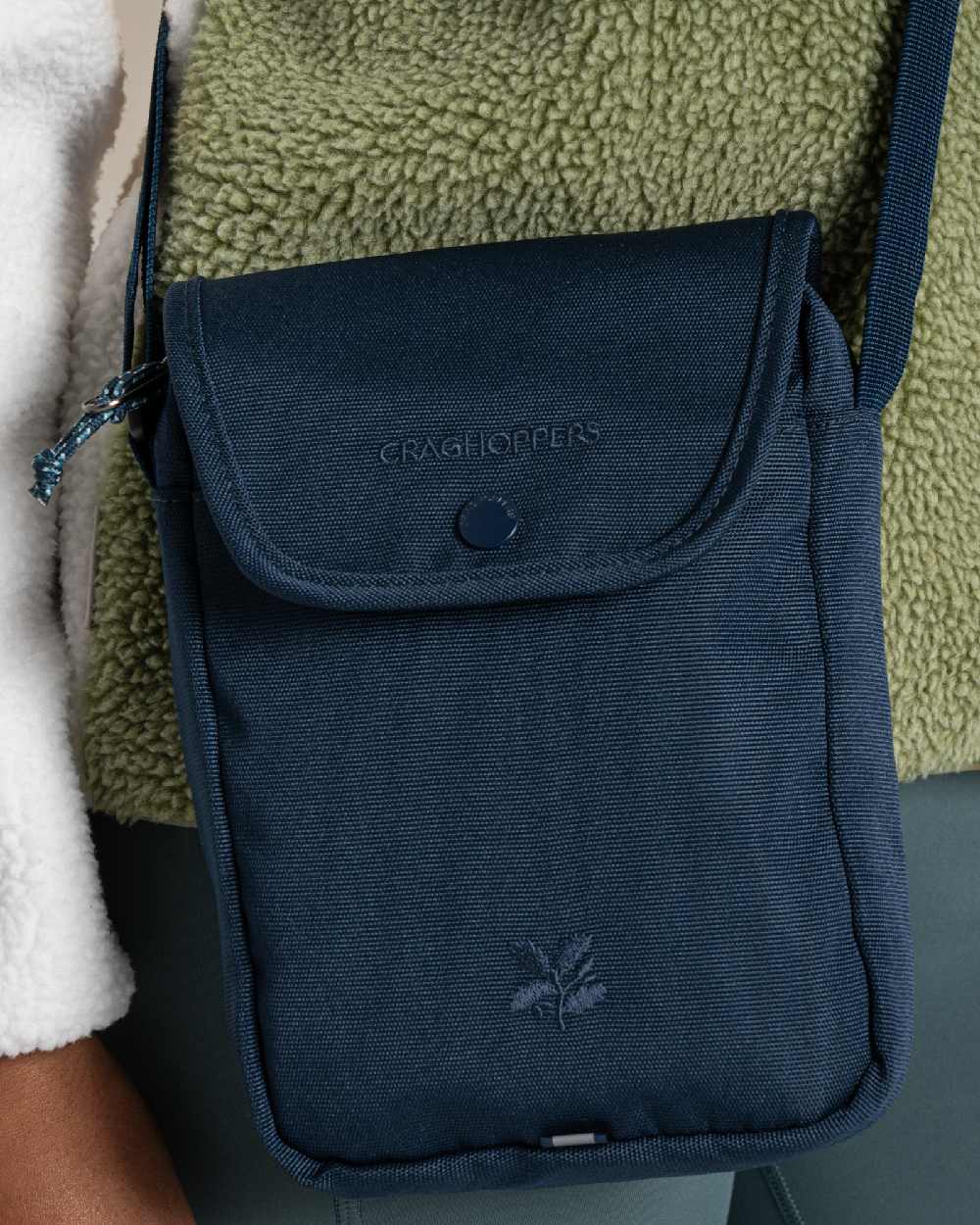 Blue Stone Coloured Craghoppers National Trust Kiwi Crossbody on Beige Background 