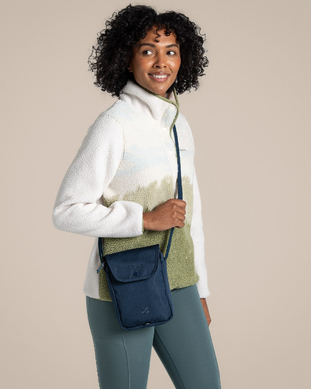 Blue Stone Coloured Craghoppers National Trust Kiwi Crossbody on Beige Background 