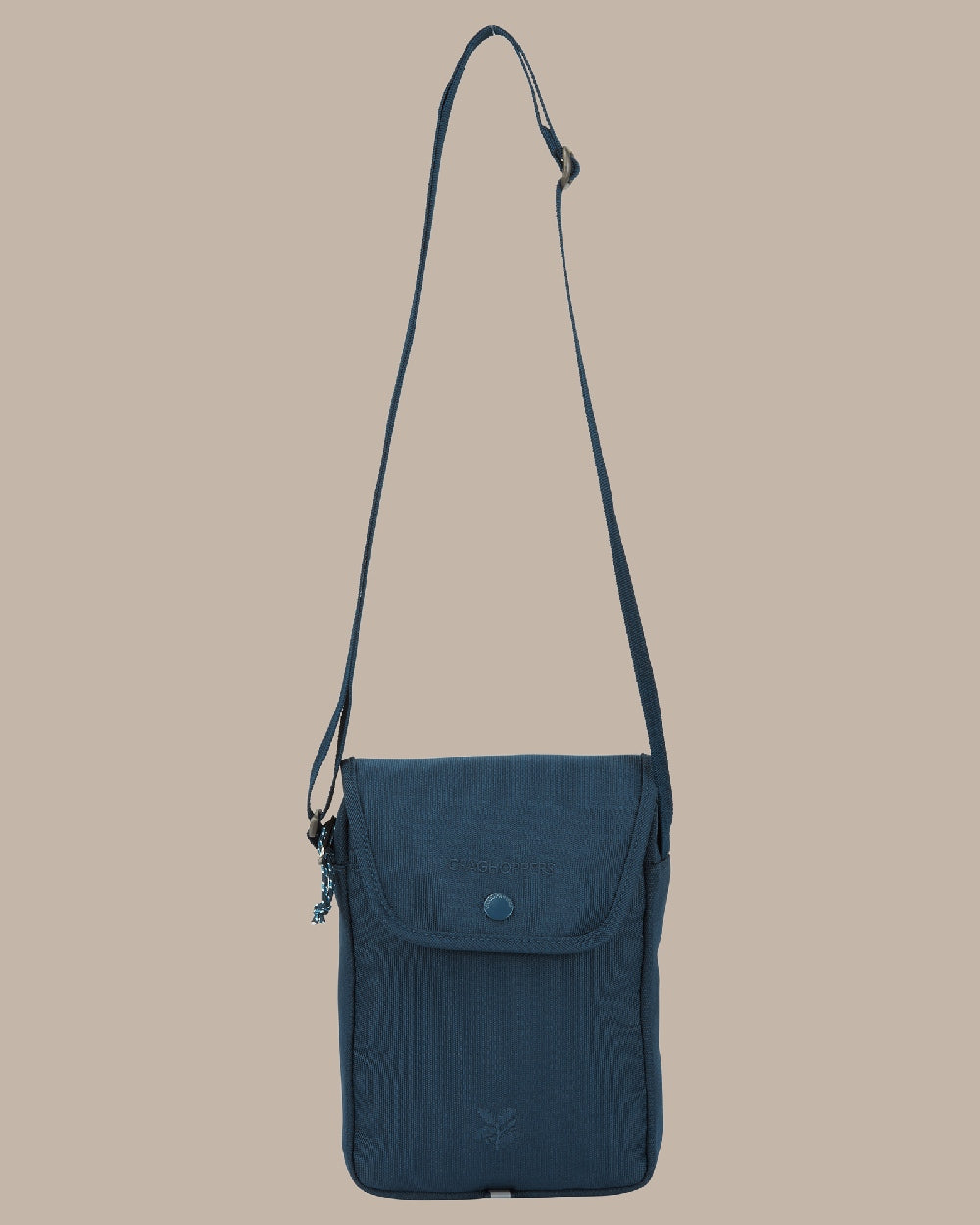 Blue Stone Coloured Craghoppers National Trust Kiwi Crossbody on Beige Background 