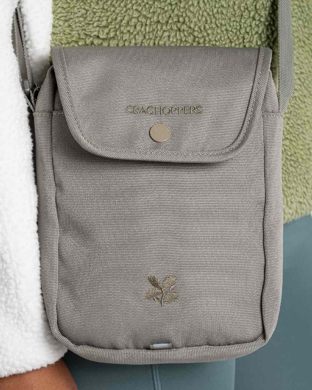Vert Coloured Craghoppers National Trust Kiwi Crossbody on Beige Background 