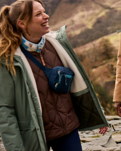 Sage coloured Craghoppers Womens National Trust Crossbill Jacket on mountain background 
