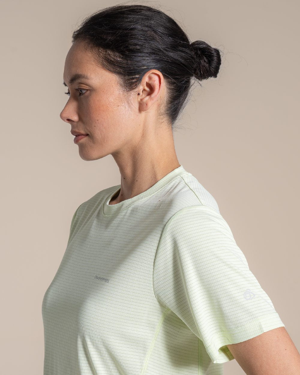 Pear Drop coloured Craghoppers Womens NosiLIfe SolarShield+ Short Sleeved T-Shirt on beige background 