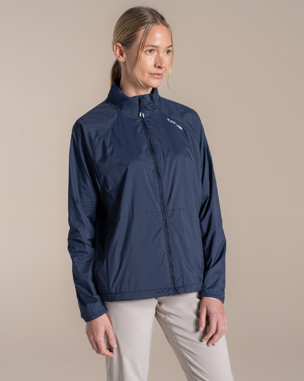 Blue Navy Coloured Craghoppers Womens Nosilife Driver Jacket on Beige Background 