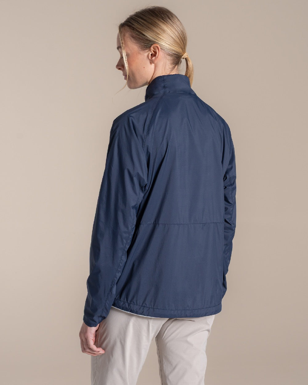 Blue Navy Coloured Craghoppers Womens Nosilife Driver Jacket on Beige Background 