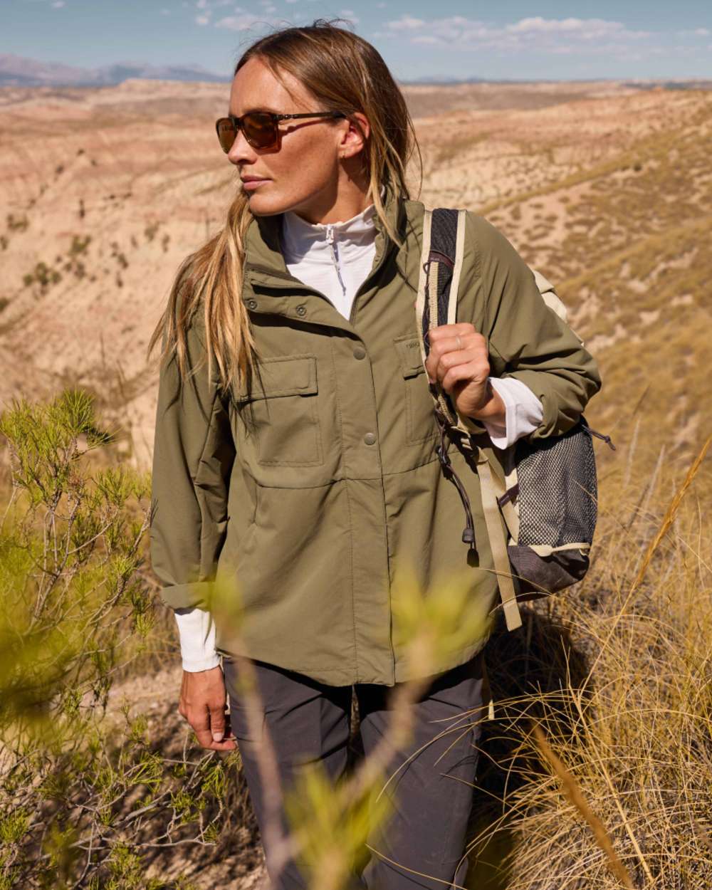 Dark Iron coloured Craghoppers Womens NosiLife Rif Stretch Cargo Trousers on mountain background 