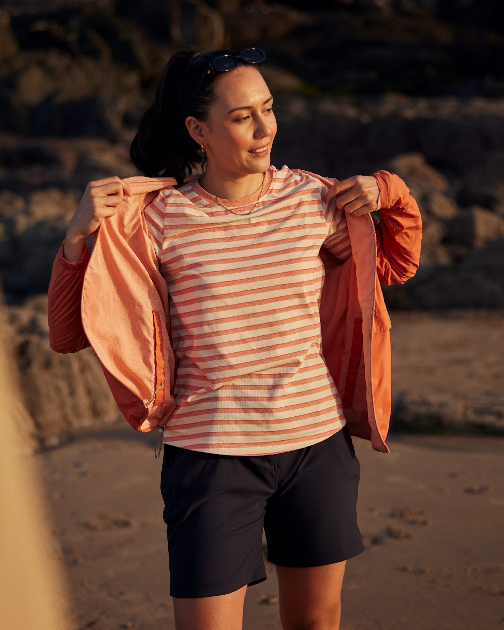 Red Sandstone Clay coloured Craghoppers Womens NosiLife Rosa Reversible Jacket on beach background 