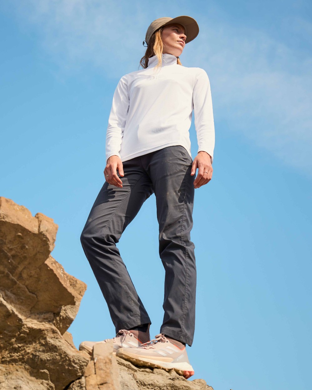 White coloured Craghoppers Womens NosiLife SolarShield+ Half Zip Top on mountain background 