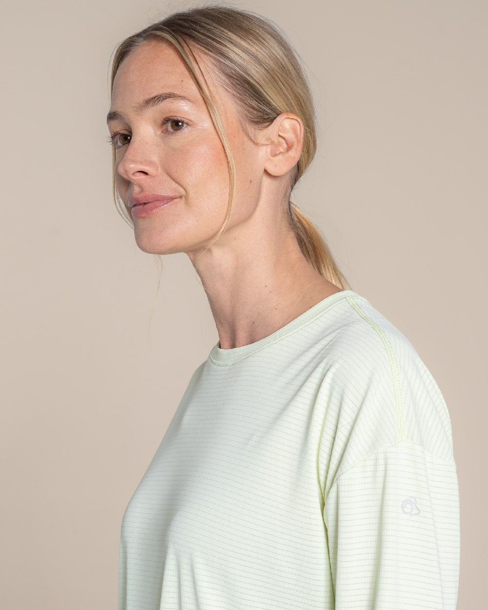 Pear Drop coloured Craghoppers Womens NosiLife SolarShield+ Long Sleeved T-Shirt on beige background 