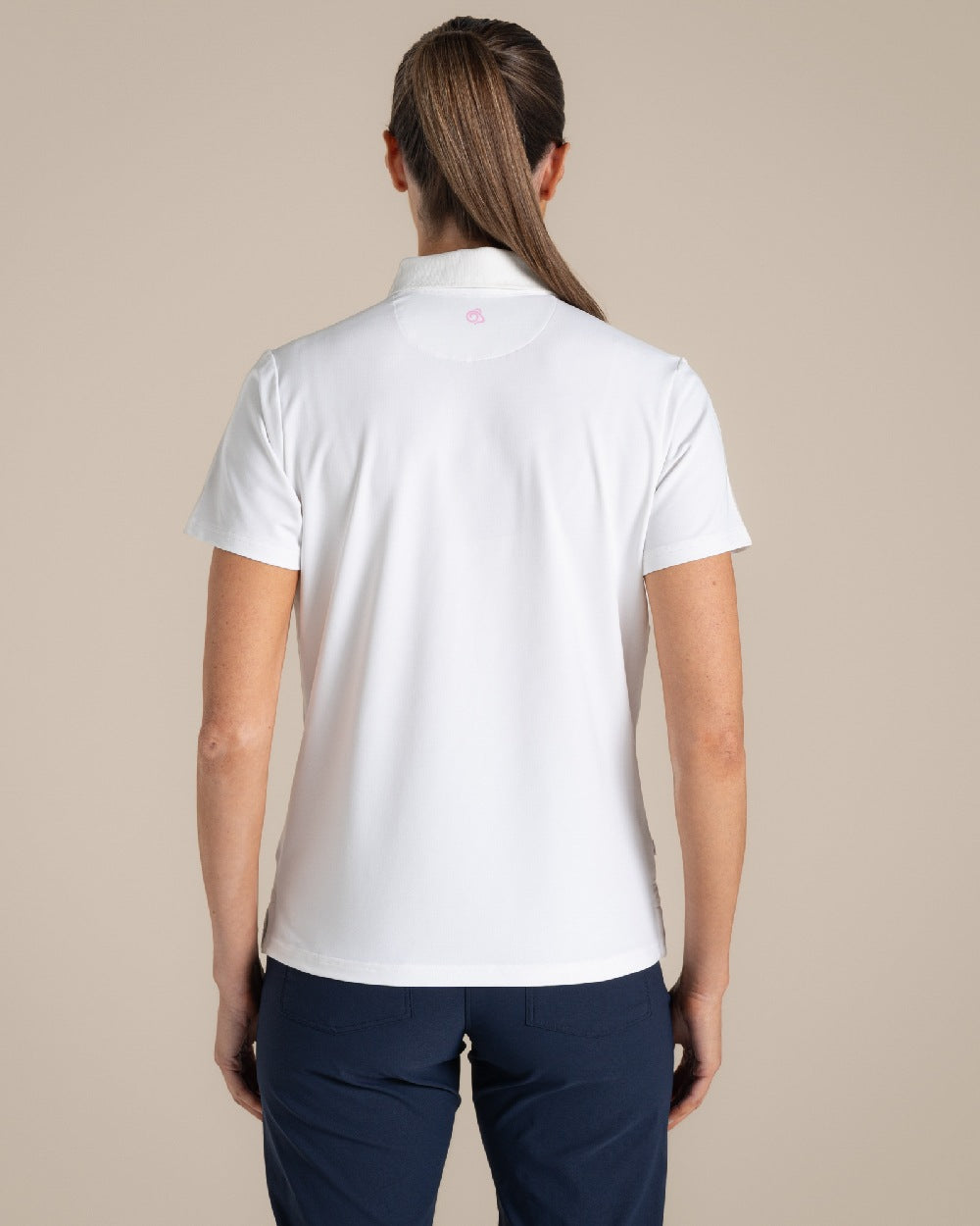 White Coloured Craghoppers Womens Nosilife Thornbuy Short Sleeved Polo Top on Beige Background 