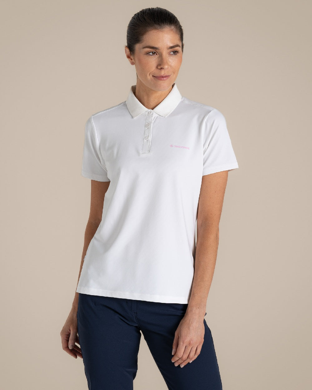 White Coloured Craghoppers Womens Nosilife Thornbuy Short Sleeved Polo Top on Beige Background 