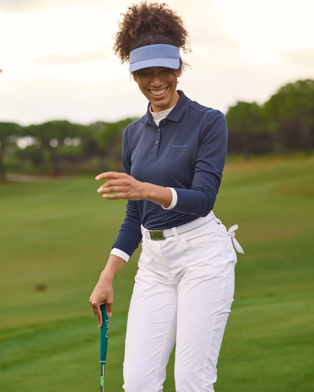 White coloured Craghoppers Womens Nosilife Milla Golf Trousers on grass background 