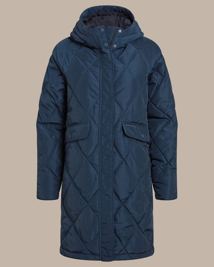 Deep teal blue colour parka, against a solid beige studio background. 