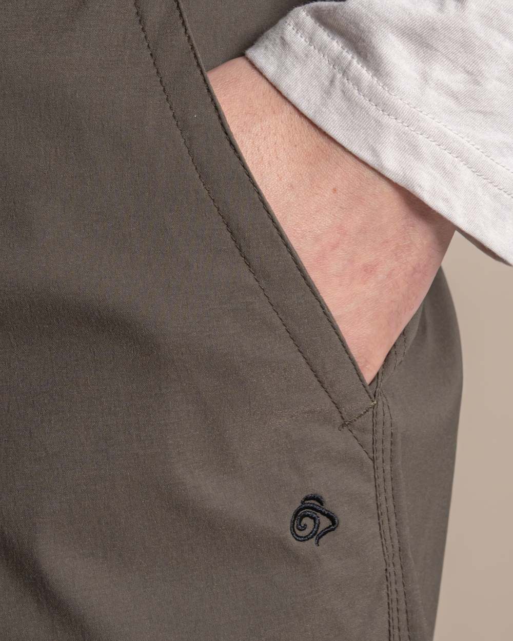 Woodland Green coloured Craghoppers Mens Brisk Pro Trouser on beige background 