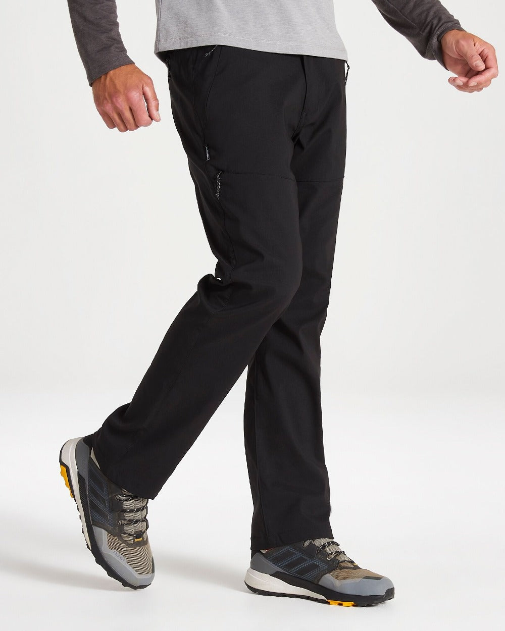 Black Coloured Craghoppers Mens Kiwi Pro II Trousers On A Grey Background 