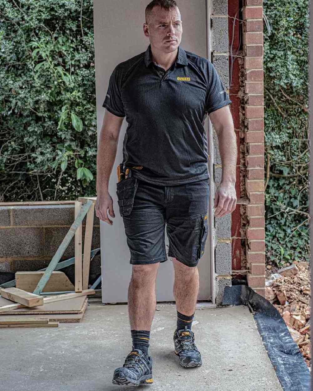 Black Coloured DeWalt Rutland Performance Polo Shirt on outdoor background 