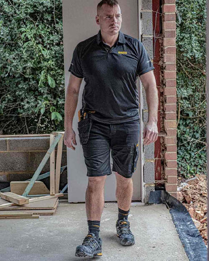 Black Coloured DeWalt Rutland Performance Polo Shirt on outdoor background 