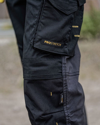 Grey coloured DeWalt Memphis Regular Fit Stretch Trousers on blurry background 