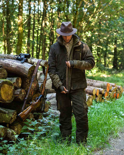 Green Coloured Deerhunter Adventurer Felt Hat on forest background 