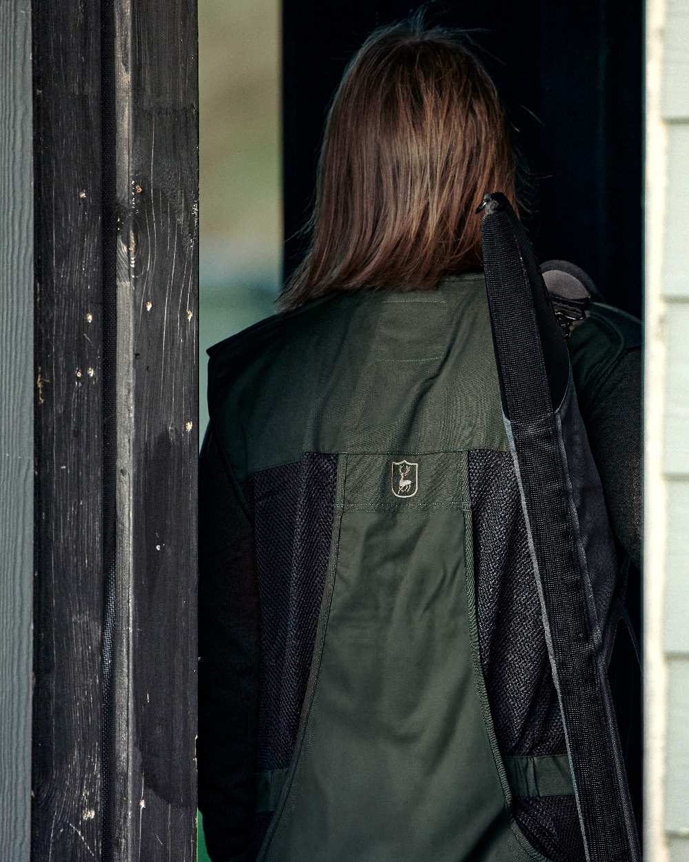 Timber coloured Deerhunter Atlas Mesh Shooting Waistcoat on blurry background 
