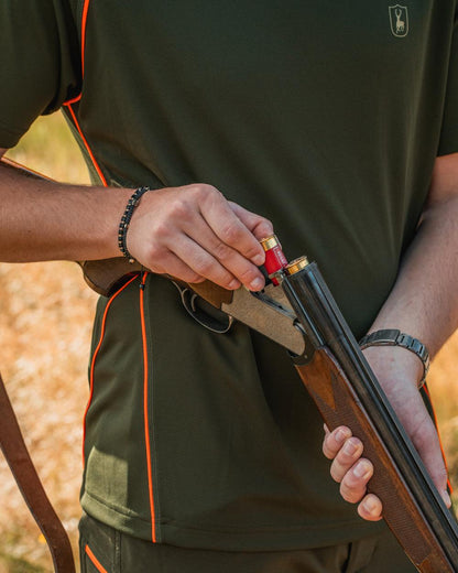 Forest Green coloured Deerhunter Chamois Short Sleeve T-Shirt on forest background 
