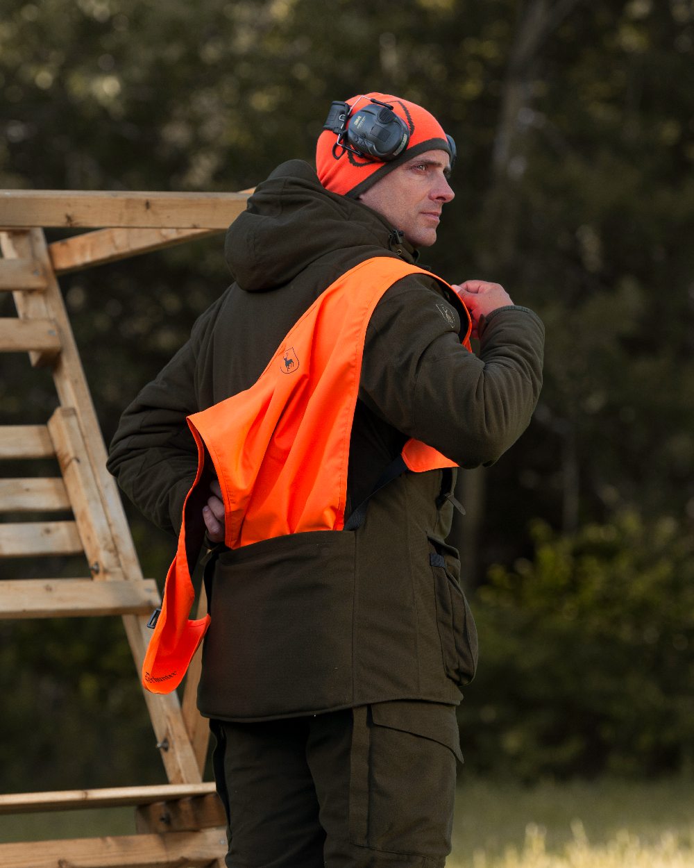 Orange Green coloured Deerhunter Cumberland Reversible Beanie on blurry background 