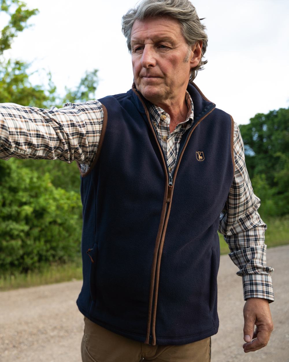 Dark Blue coloured Deerhunter Cumbria Fleece Waistcoat on forest background 