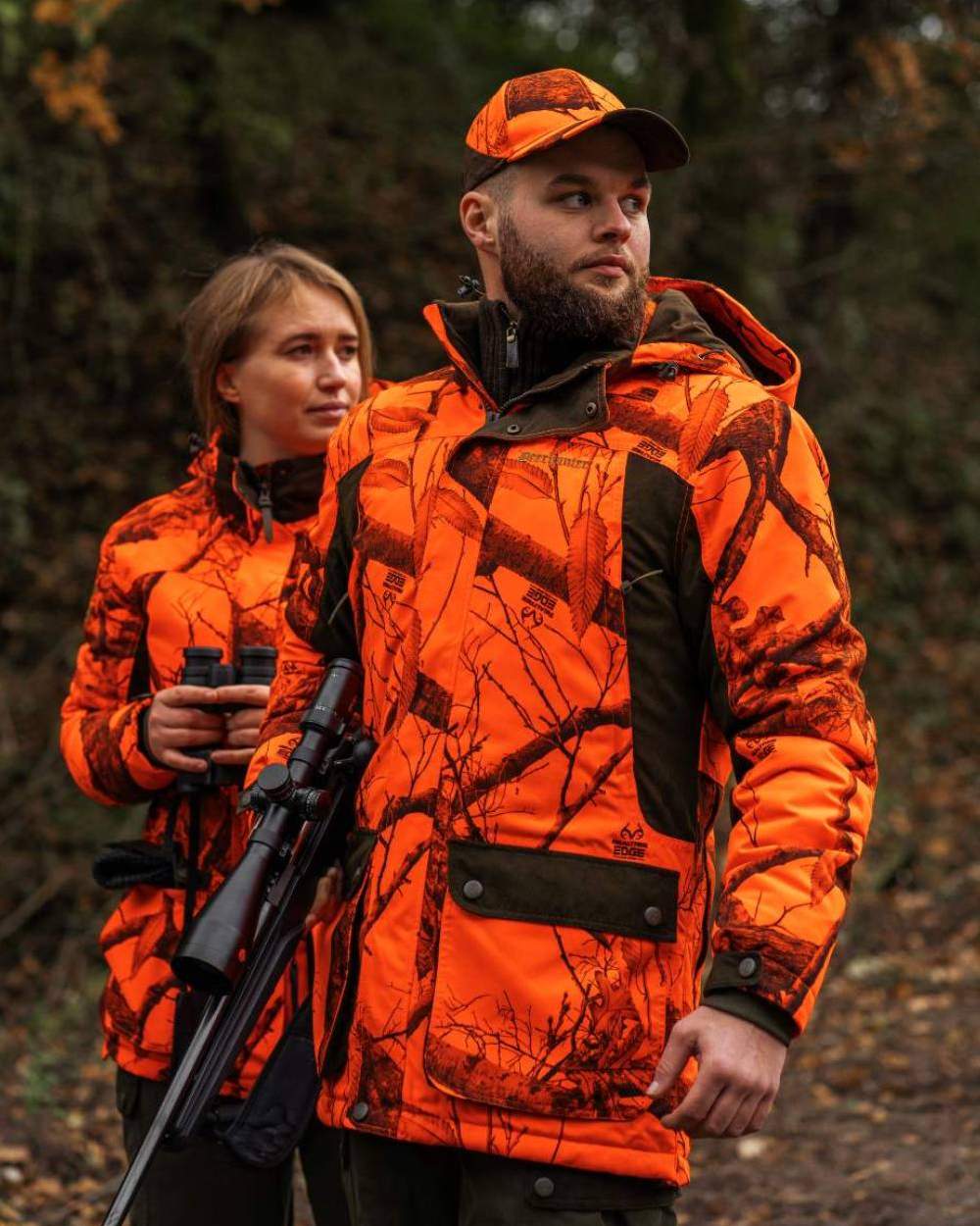Realtree Edge Orange Coloured Deerhunter Eagle Winter Jacket On A Forest Background 
